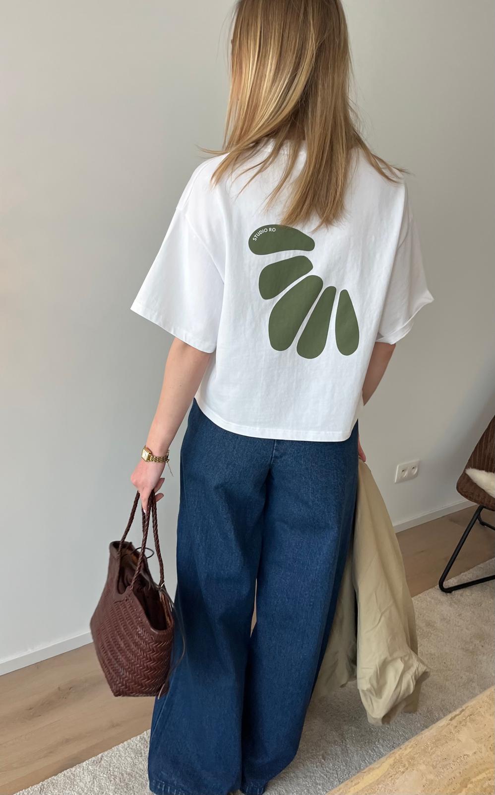 Ro Essentials oversized t-shirt with olive green leaf motif, paired with wide-leg jeans