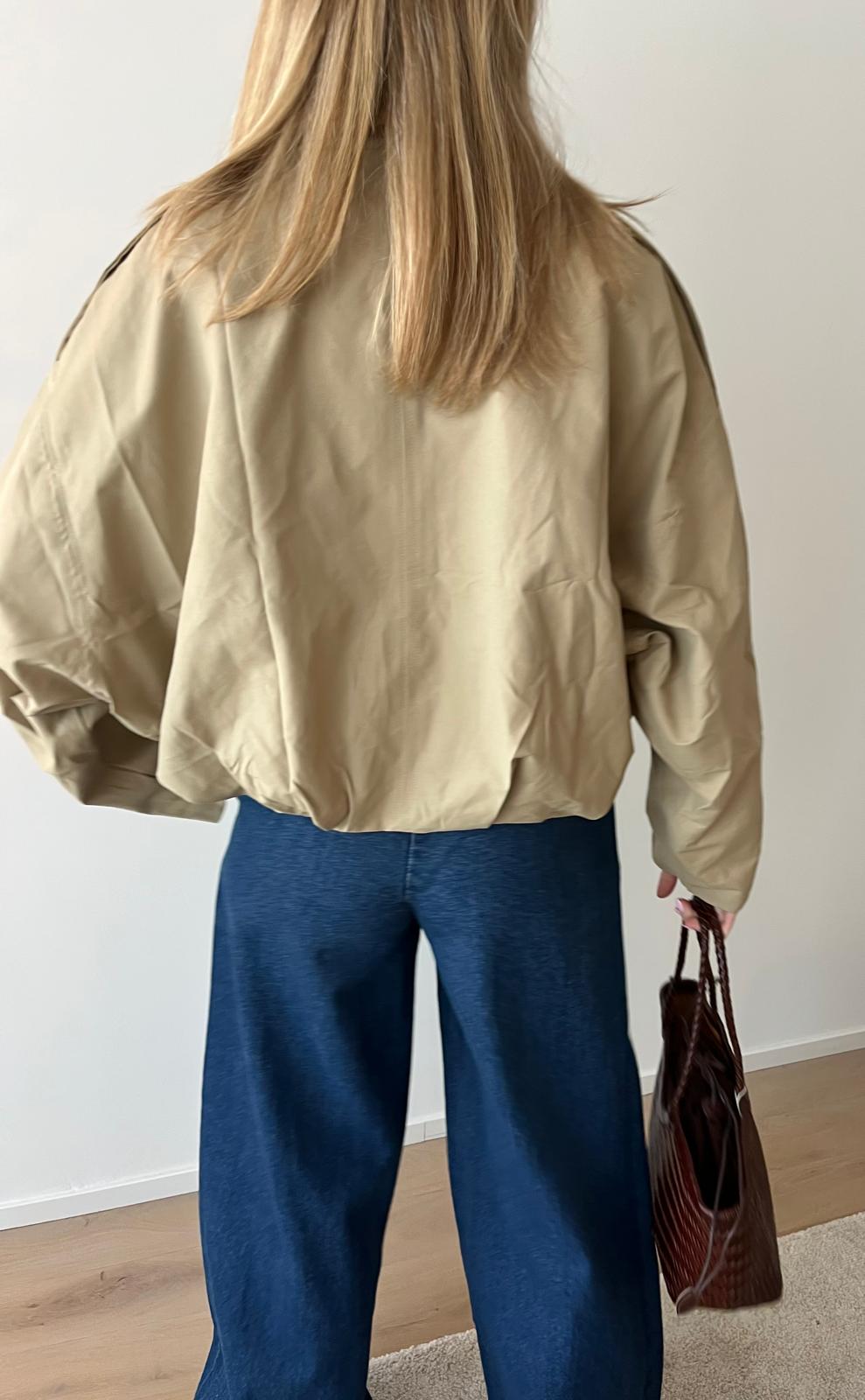 Beige bomber jacket with wide-leg jeans